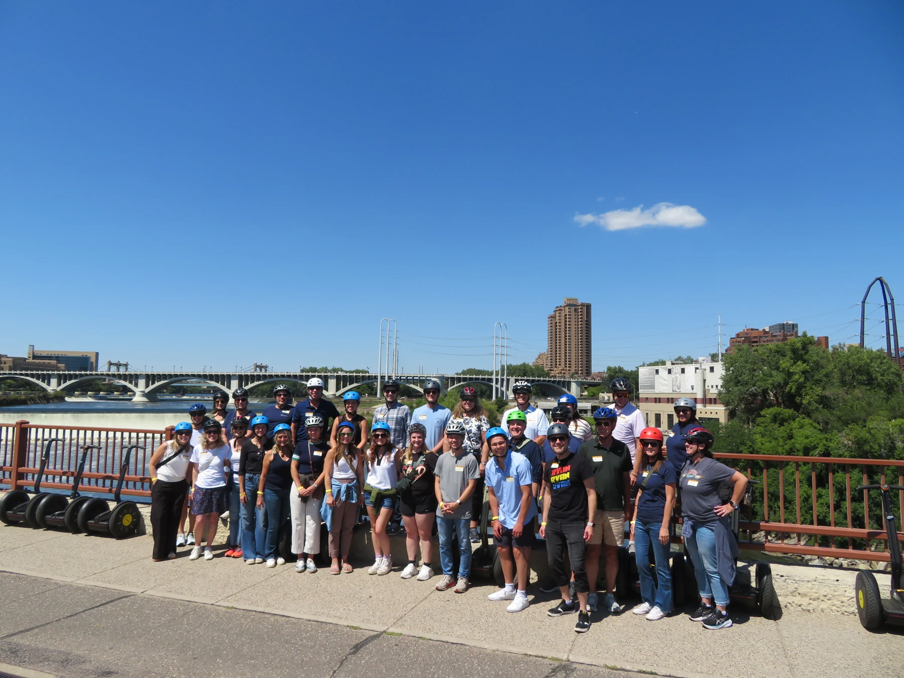 A corporate tour group with their Segways beside the Mississippi River