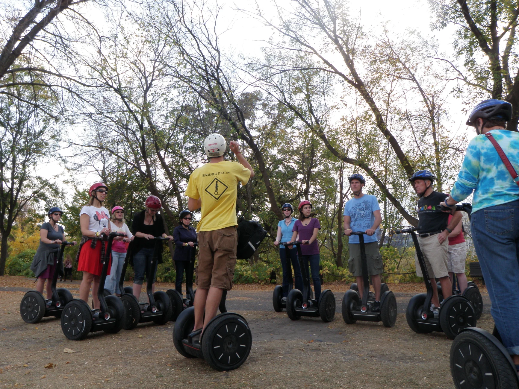 A tour guide shares a story with a group of Segway riders